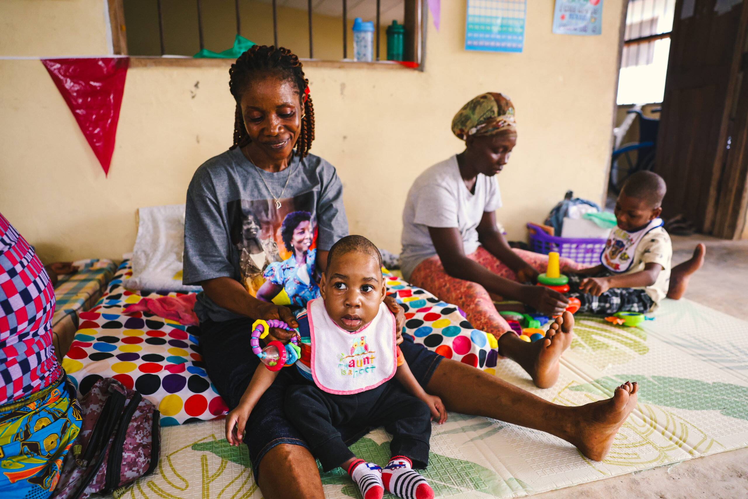 Caregiver with child at His Safe Haven Village