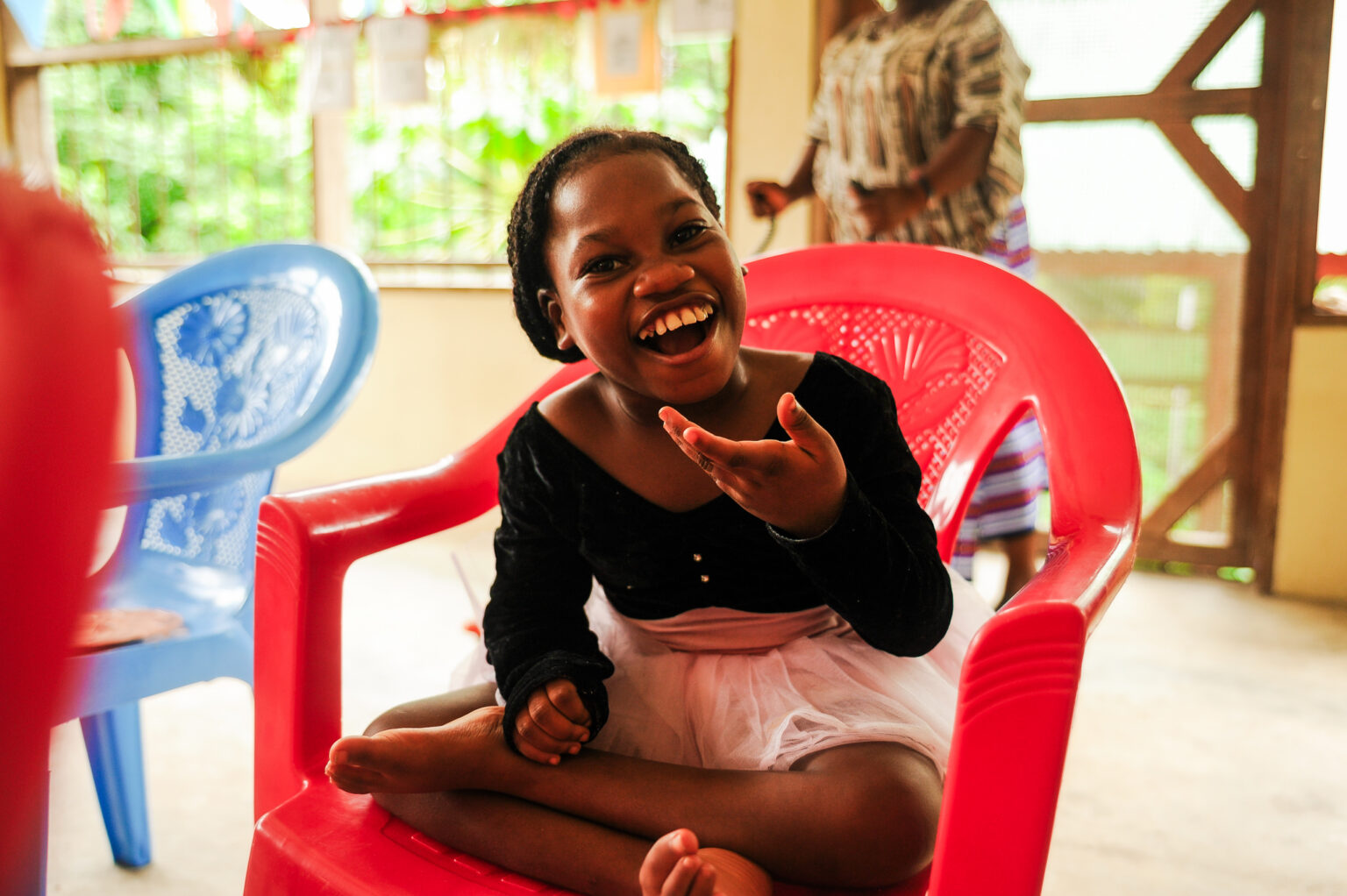 A smiling boy recovering in an inpatient bed at the Jesus Loves Me Children's Center