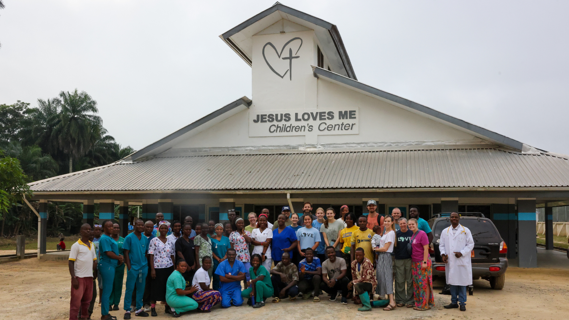 The doctors, nurses and staff of the Jesus Loves Me Children's Center gathered outside the building