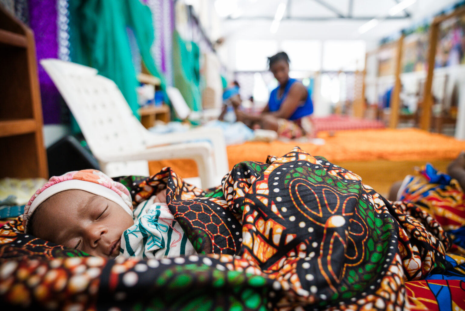 A baby sleeps peacefully on the ward at the Jesus Loves Me Children's Center