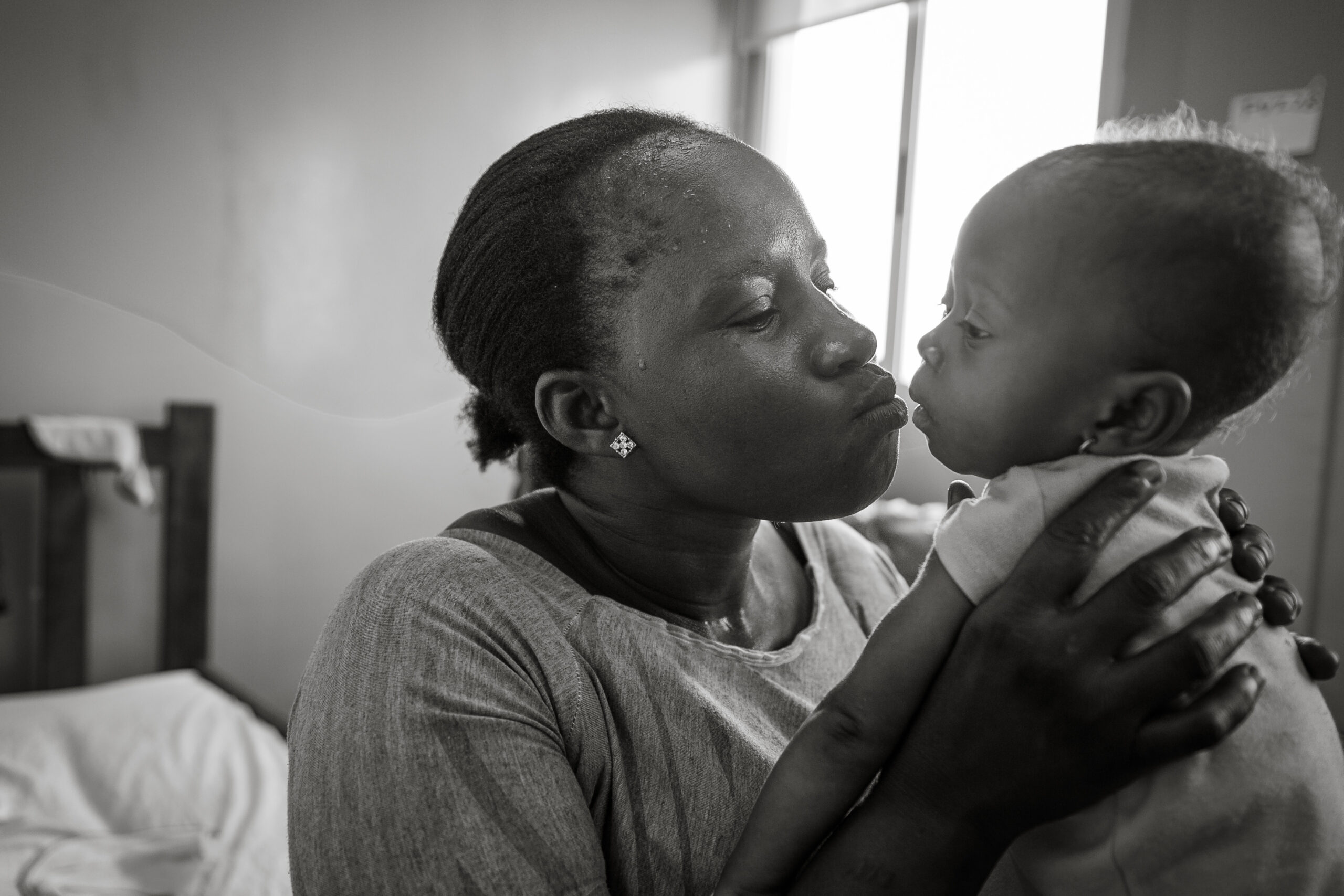 A Liberian mother holds her baby close for a kiss.
