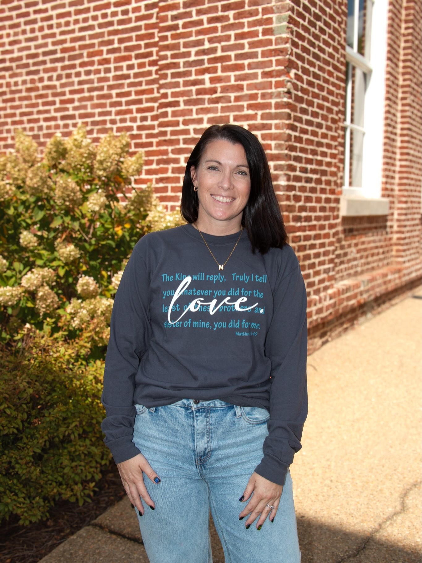 A woman in a charcoal love tee.