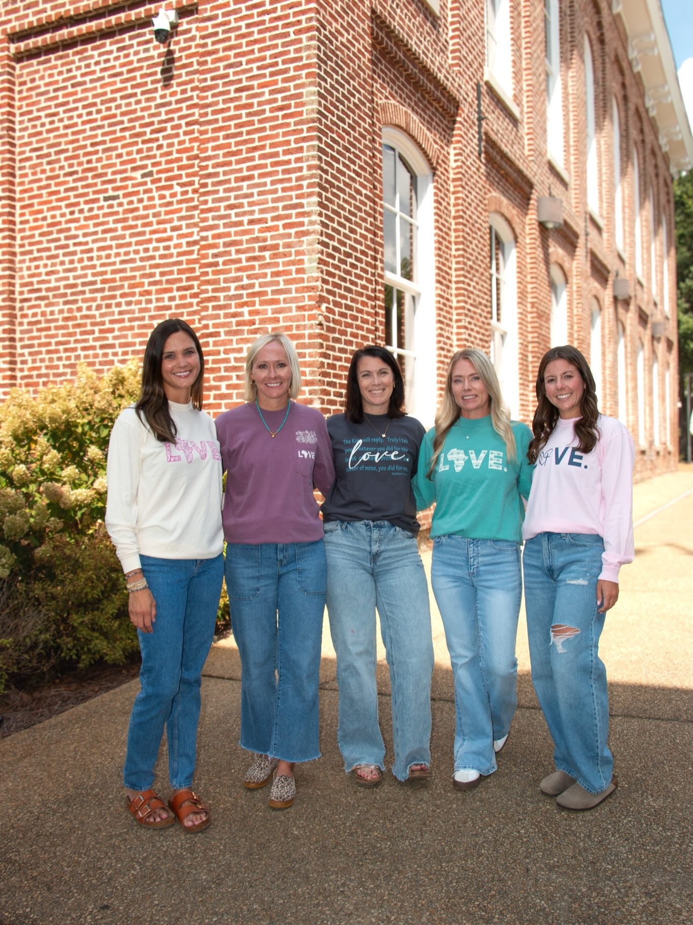 Five friends model the new fall LOVE. collection outside the store.