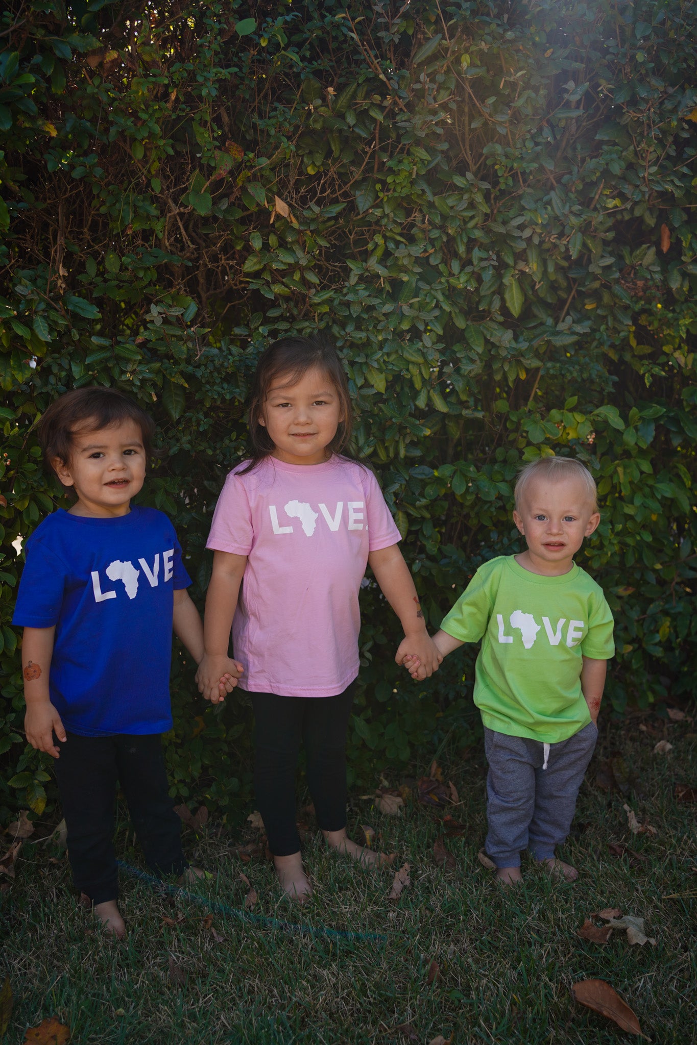 Three kids in colorful LOVE. tees.